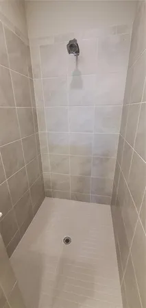 an empty room with a ceiling fan and a window