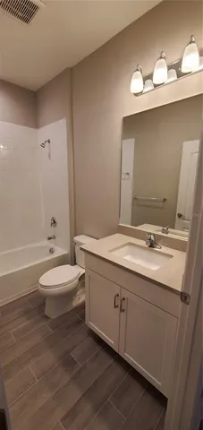 a bathroom with a toilet and a bath tub
