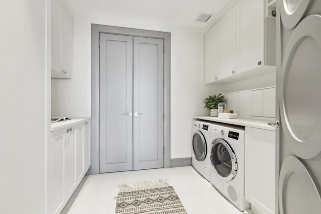 a view of a storage and utility room with washer and dryer
