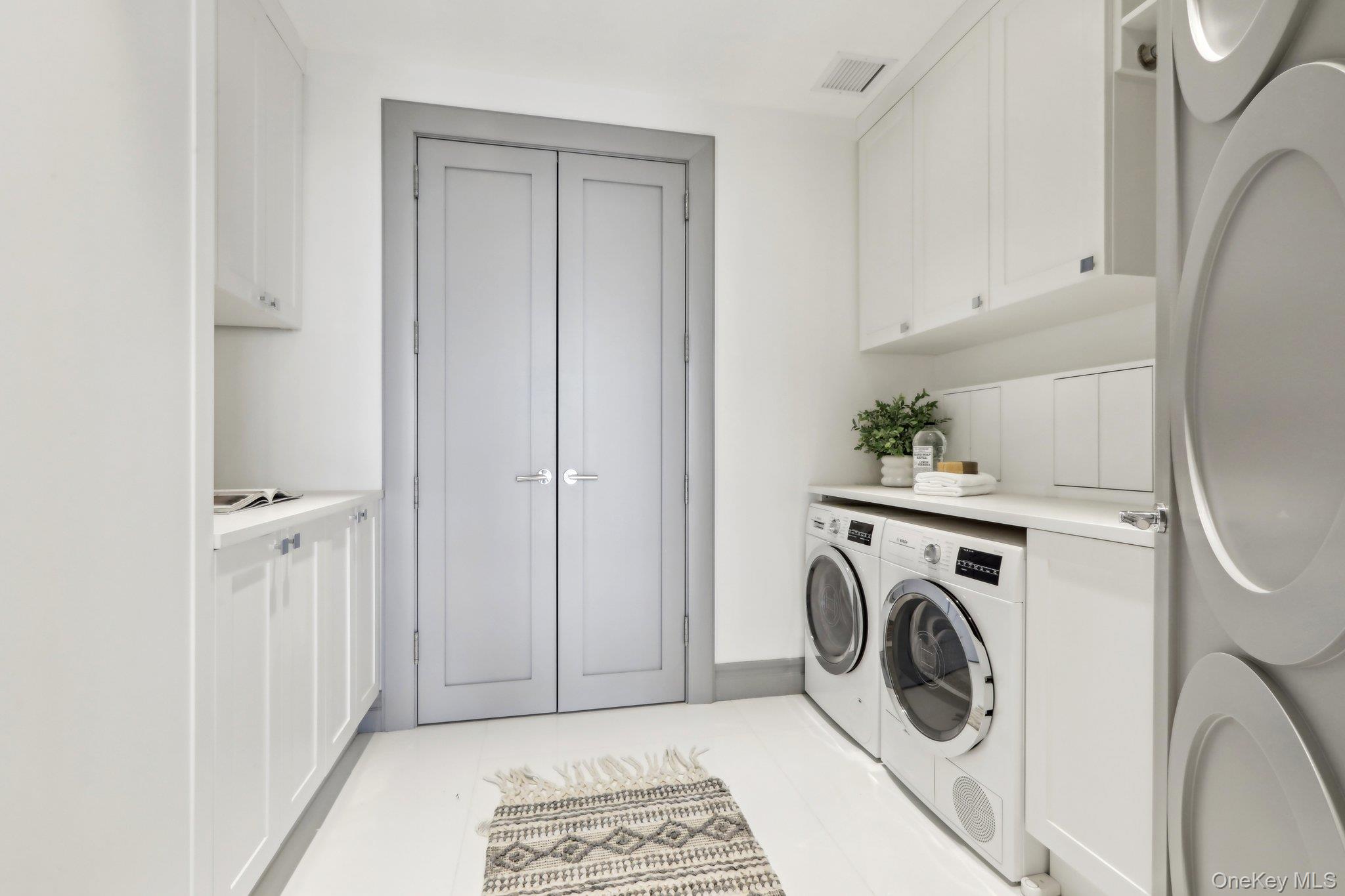 5 Renaissance Square, Unit PH41G White Plains, NY 10601 - Photo 17 of 26 a view of a storage and utility room with washer and dryer