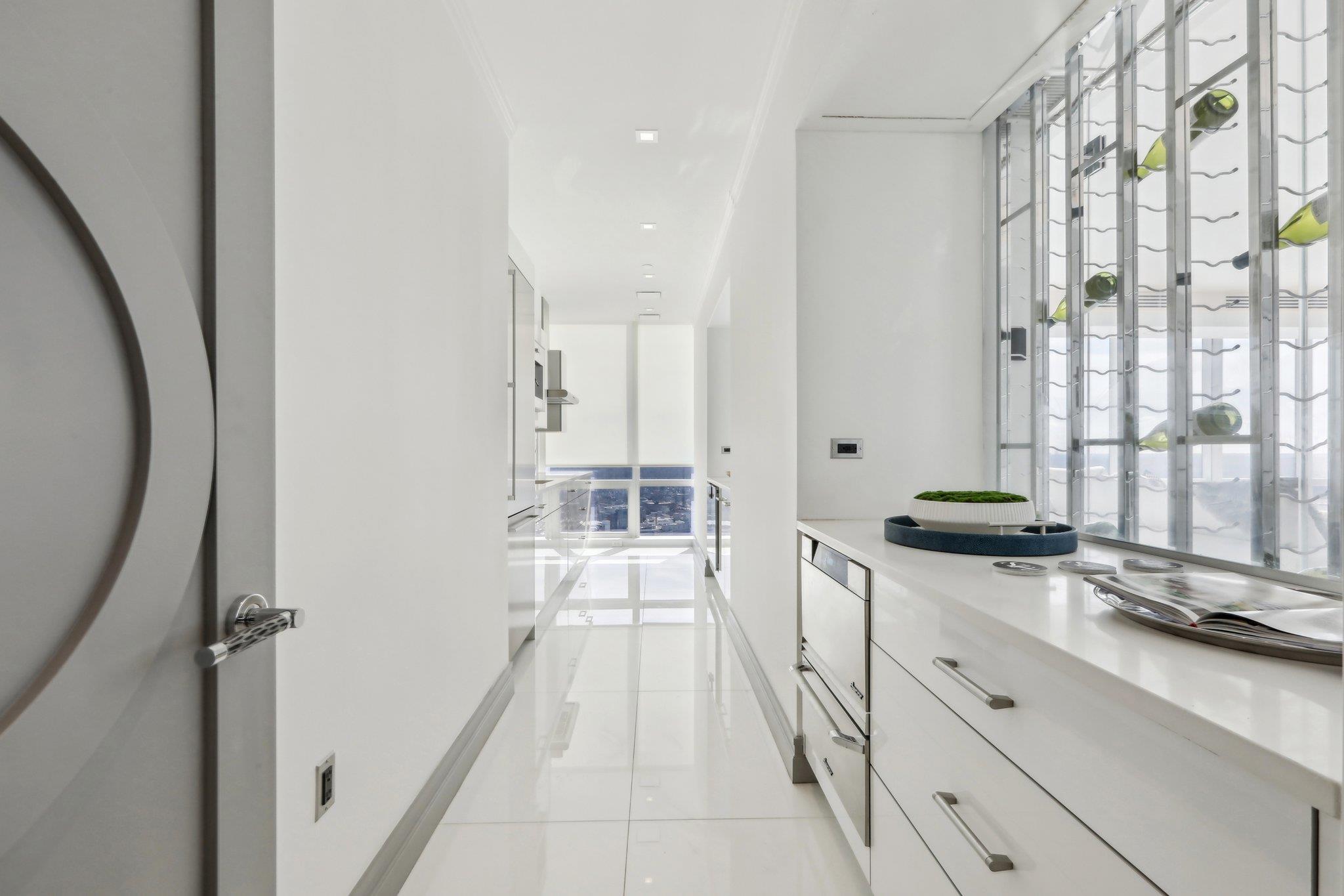 5 Renaissance Square, Unit PH41G White Plains, NY 10601 - Photo 10 of 26 a large white kitchen with granite countertop a sink
