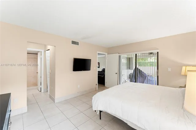 a room with a bed and a television