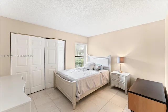 a bedroom with a bed and a night stand