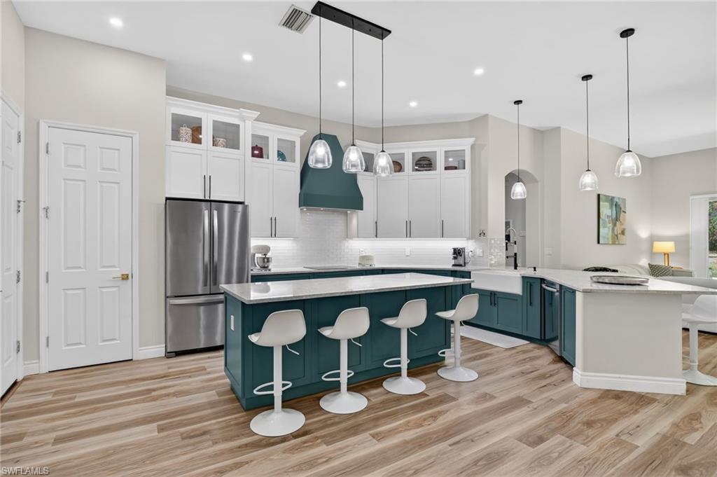 2065 Mandarin Lane Naples, FL 34120 - Photo 17 of 46 a large kitchen with a table and chairs