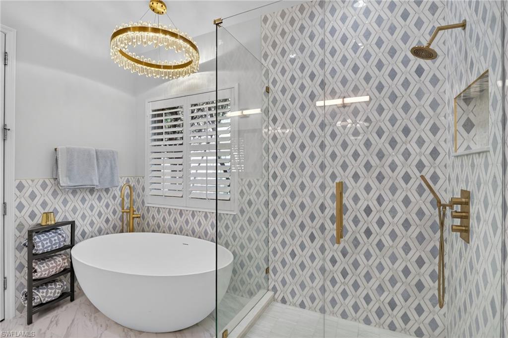 2065 Mandarin Lane Naples, FL 34120 - Photo 2 of 46 a bathroom with a bathtub and shower