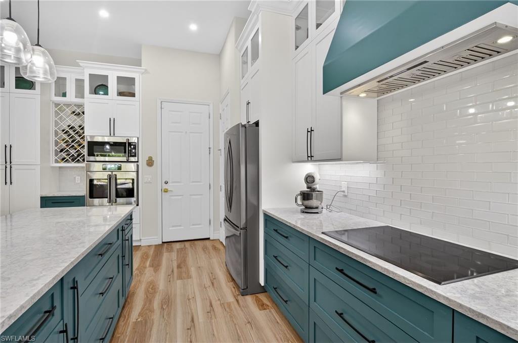 2065 Mandarin Lane Naples, FL 34120 - Photo 22 of 46 a kitchen with granite countertop a refrigerator a sink dishwasher stove and oven