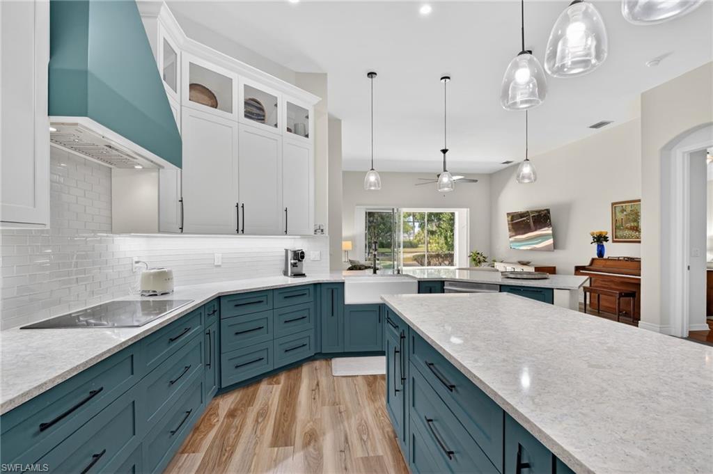2065 Mandarin Lane Naples, FL 34120 - Photo 23 of 46 a large kitchen with granite countertop a sink counter space cabinets and stainless steel appliances