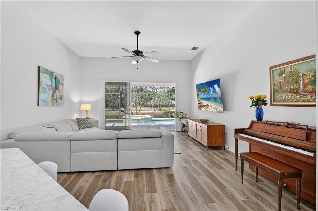 2065 Mandarin Lane Naples, FL 34120 - Photo 24 of 46 a living room with furniture and a flat screen tv