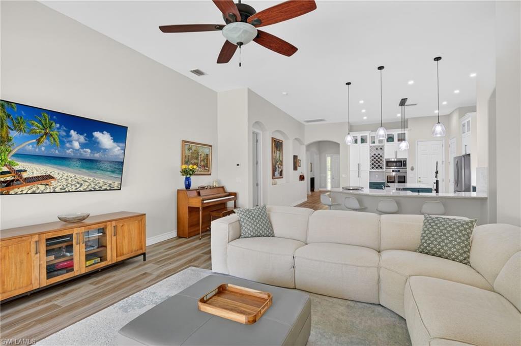 2065 Mandarin Lane Naples, FL 34120 - Photo 27 of 46 a living room with furniture and a flat screen tv