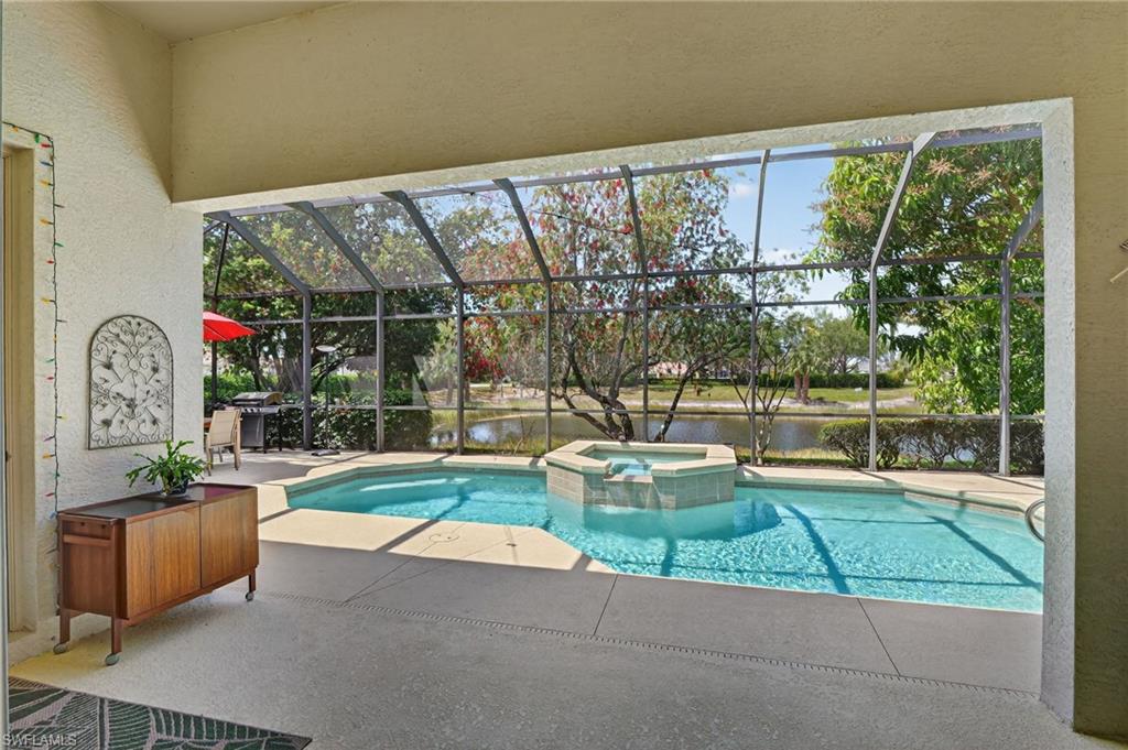 2065 Mandarin Lane Naples, FL 34120 - Photo 28 of 46 a view of swimming pool with outdoor seating and plants