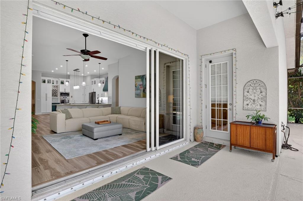 2065 Mandarin Lane Naples, FL 34120 - Photo 30 of 46 a living room with furniture and a window