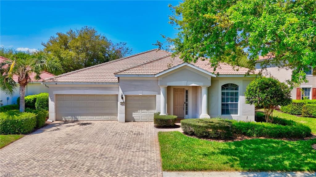 2065 Mandarin Lane Naples, FL 34120 - Photo 3 of 46 a view of a white house with a small yard and large tree