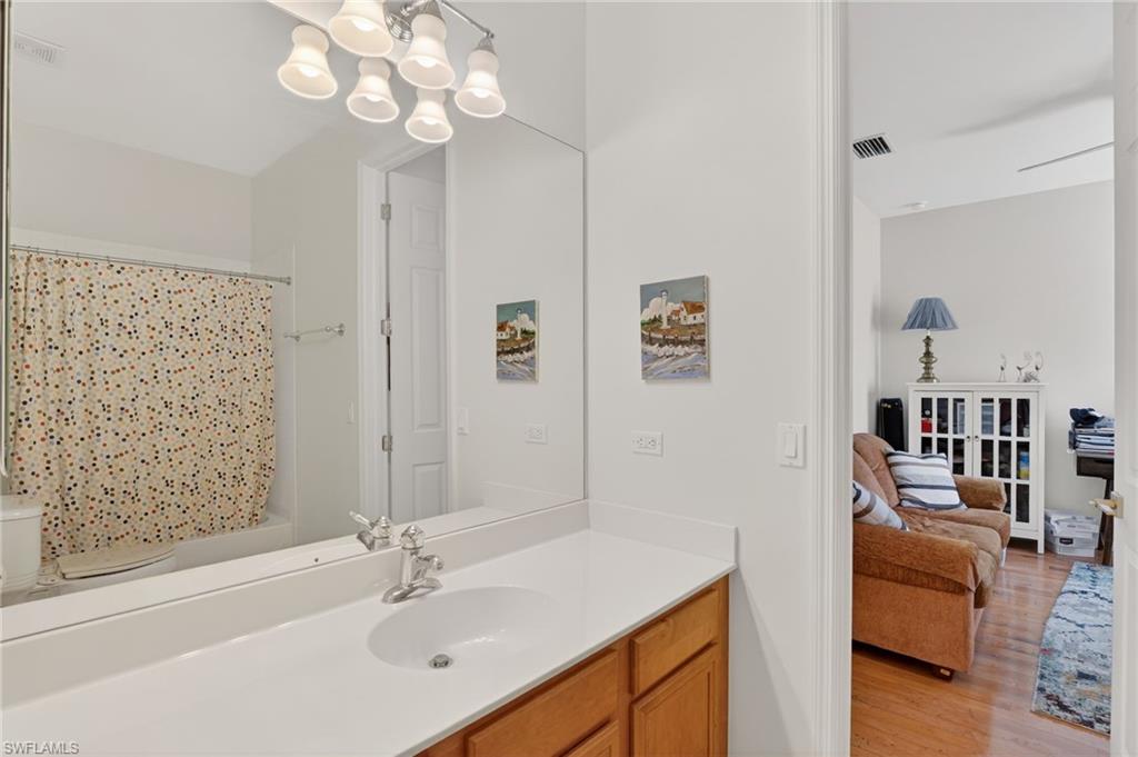 2065 Mandarin Lane Naples, FL 34120 - Photo 38 of 46 a bathroom with a sink a vanity and a mirror