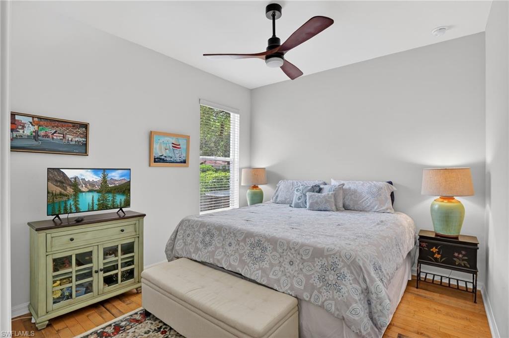 2065 Mandarin Lane Naples, FL 34120 - Photo 40 of 46 a bedroom with a bed and a flat tv screen on dresser