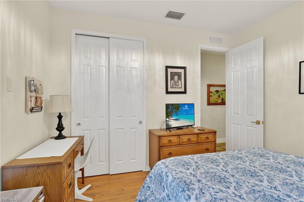 2065 Mandarin Lane Naples, FL 34120 - Photo 43 of 46 a bedroom with a bed and a table in it