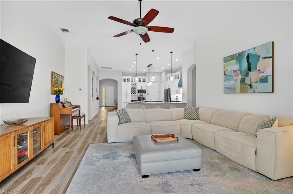 2065 Mandarin Lane Naples, FL 34120 - Photo 5 of 46 a living room with furniture and a flat screen tv