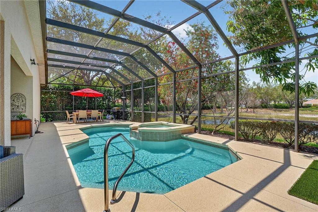 2065 Mandarin Lane Naples, FL 34120 - Photo 9 of 46 a view of a swimming pool with a patio