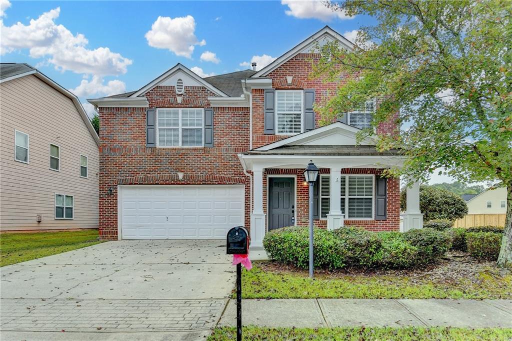 2748 Farmstead Court Grayson, GA 30017 - Photo 1 of 83 a front view of a house with a garden and plants