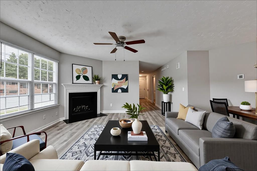 2748 Farmstead Court Grayson, GA 30017 - Photo 17 of 83 a living room with furniture a fireplace and a flat screen tv