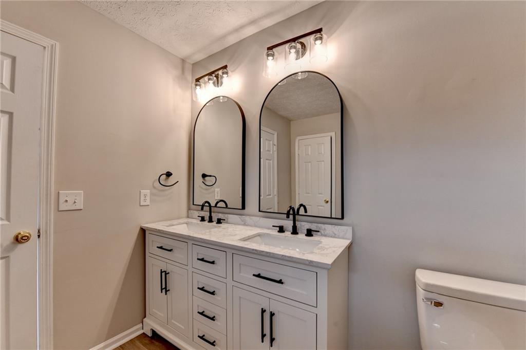 2748 Farmstead Court Grayson, GA 30017 - Photo 23 of 83 a bathroom with a double vanity sink and a mirror