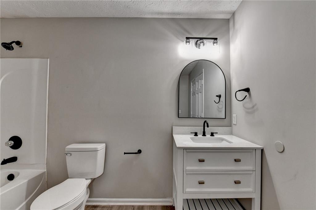 2748 Farmstead Court Grayson, GA 30017 - Photo 25 of 83 a bathroom with a toilet sink and mirror