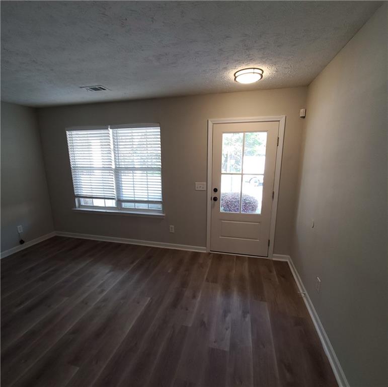2748 Farmstead Court Grayson, GA 30017 - Photo 26 of 83 a view of an empty room with wooden floor and a window