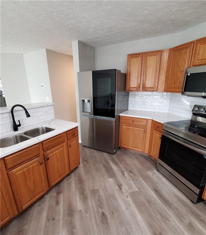 2748 Farmstead Court Grayson, GA 30017 - Photo 29 of 83 a kitchen with stainless steel appliances granite countertop a sink stove and refrigerator