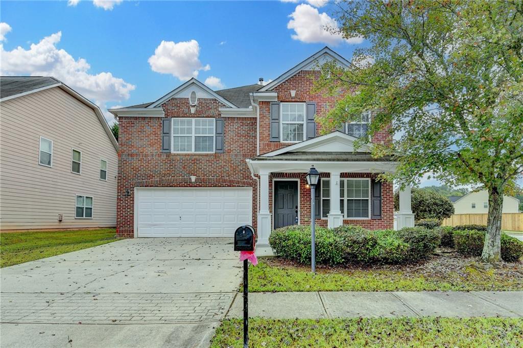2748 Farmstead Court Grayson, GA 30017 - Photo 3 of 83 a front view of a house with a yard and potted plants