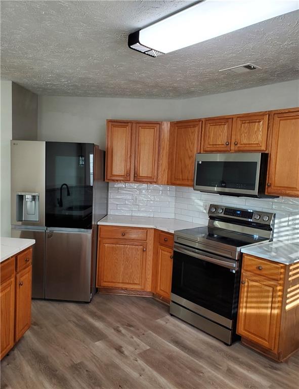 2748 Farmstead Court Grayson, GA 30017 - Photo 33 of 83 a kitchen with stainless steel appliances kitchen island granite countertop a stove and a microwave