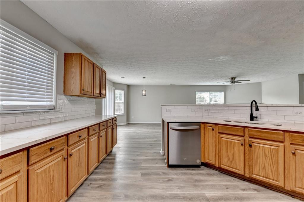 2748 Farmstead Court Grayson, GA 30017 - Photo 39 of 83 a kitchen with stainless steel appliances granite countertop a sink and cabinets