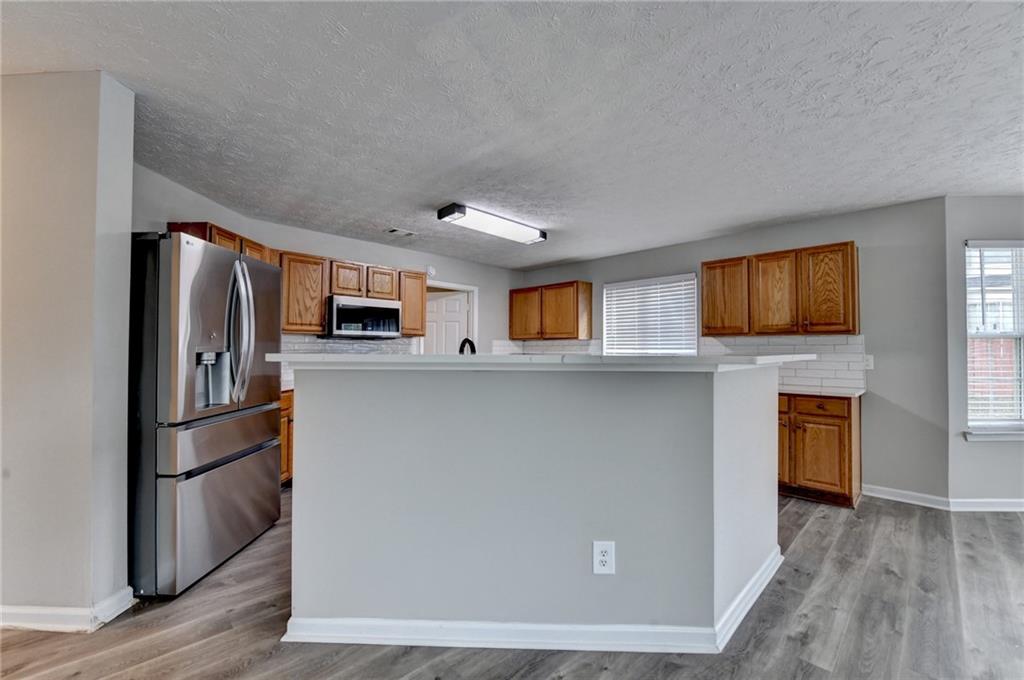 2748 Farmstead Court Grayson, GA 30017 - Photo 46 of 83 a kitchen with stainless steel appliances a refrigerator stove and microwave