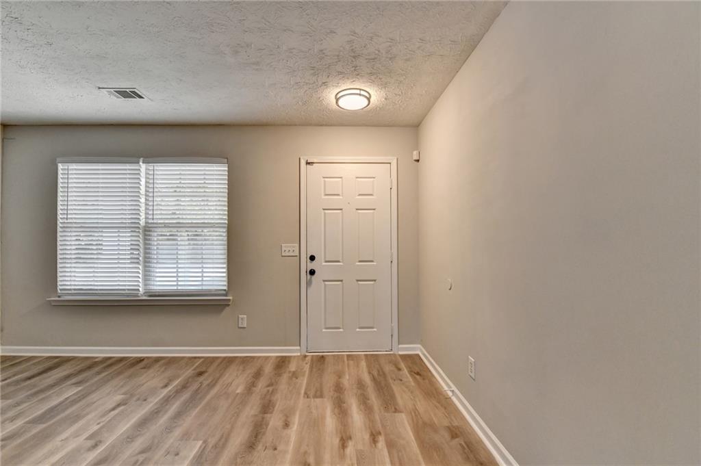 2748 Farmstead Court Grayson, GA 30017 - Photo 57 of 83 a view of an empty room with wooden floor and a window