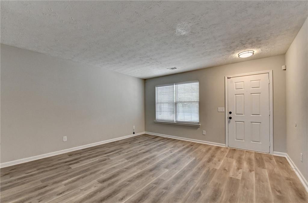 2748 Farmstead Court Grayson, GA 30017 - Photo 58 of 83 a view of an empty room with wooden floor and a window
