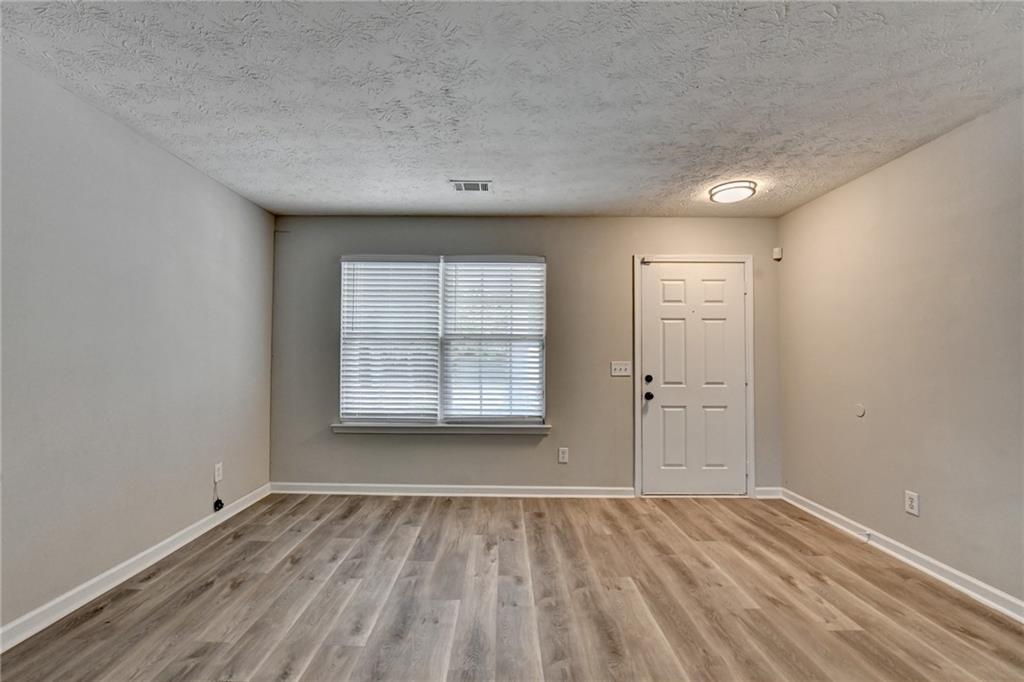 2748 Farmstead Court Grayson, GA 30017 - Photo 59 of 83 an empty room with wooden floor and windows