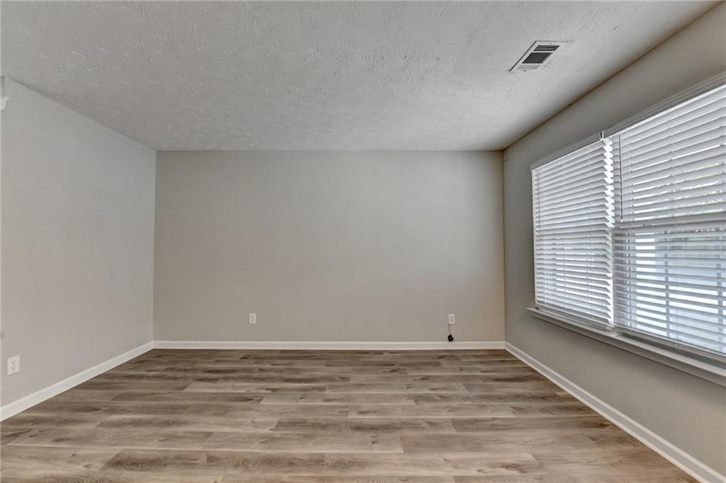 2748 Farmstead Court Grayson, GA 30017 - Photo 63 of 83 a view of a room with wooden floor and a window