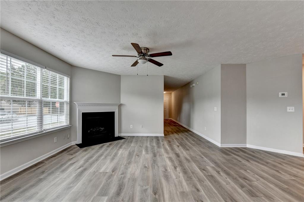 2748 Farmstead Court Grayson, GA 30017 - Photo 67 of 83 wooden floor in an empty room with a fireplace