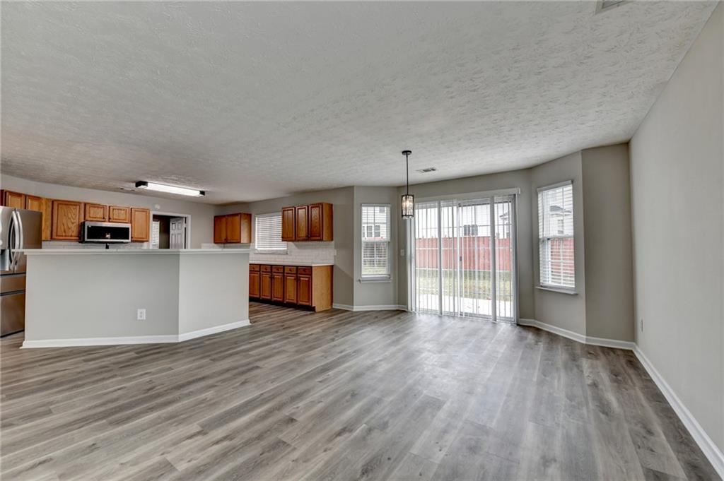 2748 Farmstead Court Grayson, GA 30017 - Photo 69 of 83 a living room with stainless steel appliances kitchen island hardwood floor and a large window