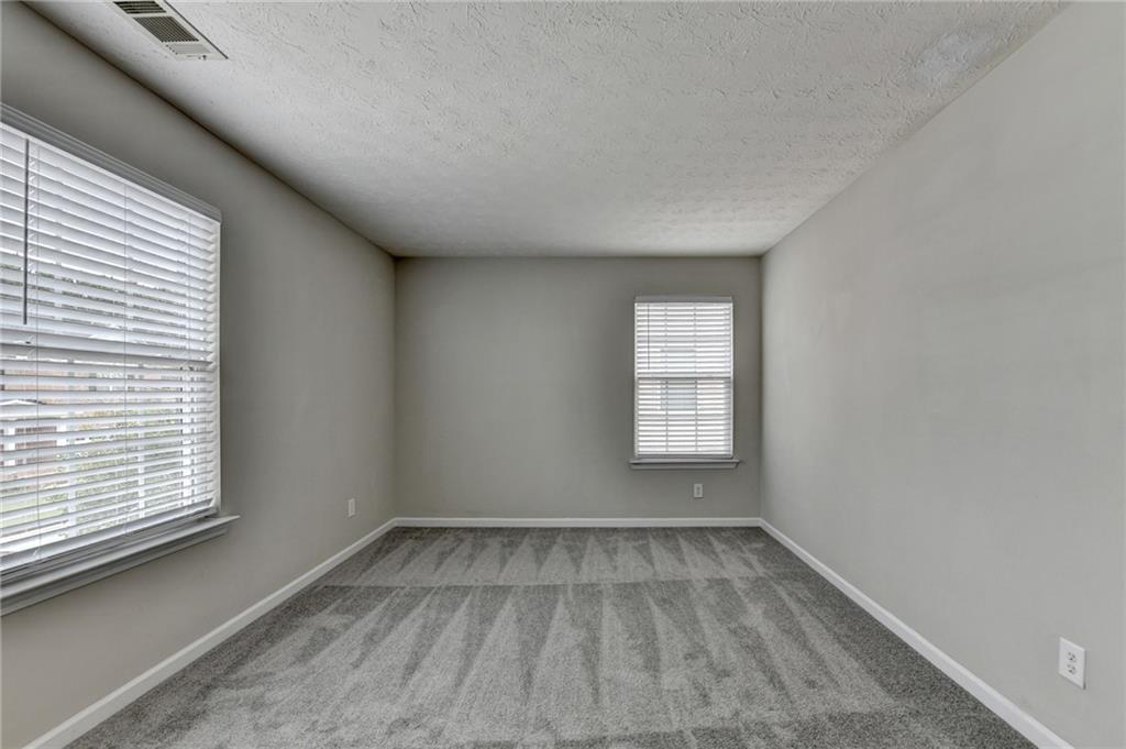 2748 Farmstead Court Grayson, GA 30017 - Photo 73 of 83 a view of a room that has wooden floor and windows in a room
