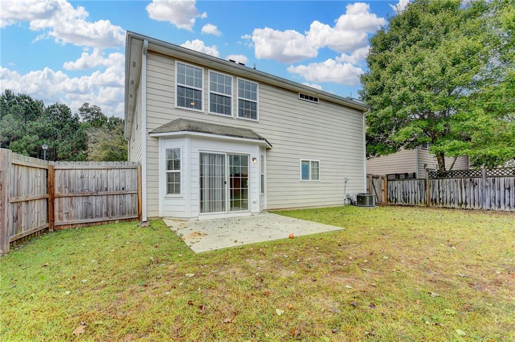 2748 Farmstead Court Grayson, GA 30017 - Photo 78 of 83 a front view of a house with a yard and garage