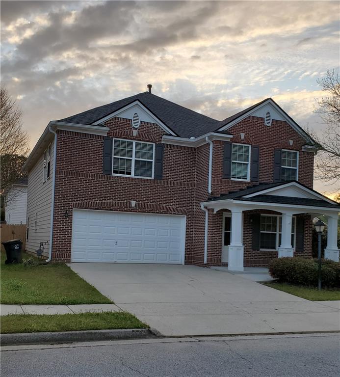 2748 Farmstead Court Grayson, GA 30017 - Photo 81 of 83 a front view of a house with a yard and garage