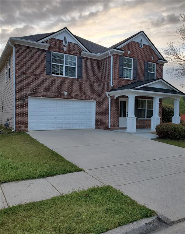 2748 Farmstead Court Grayson, GA 30017 - Photo 10 of 83 a front view of a house with a garden