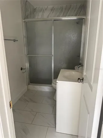 a bathroom with a shower and a sink