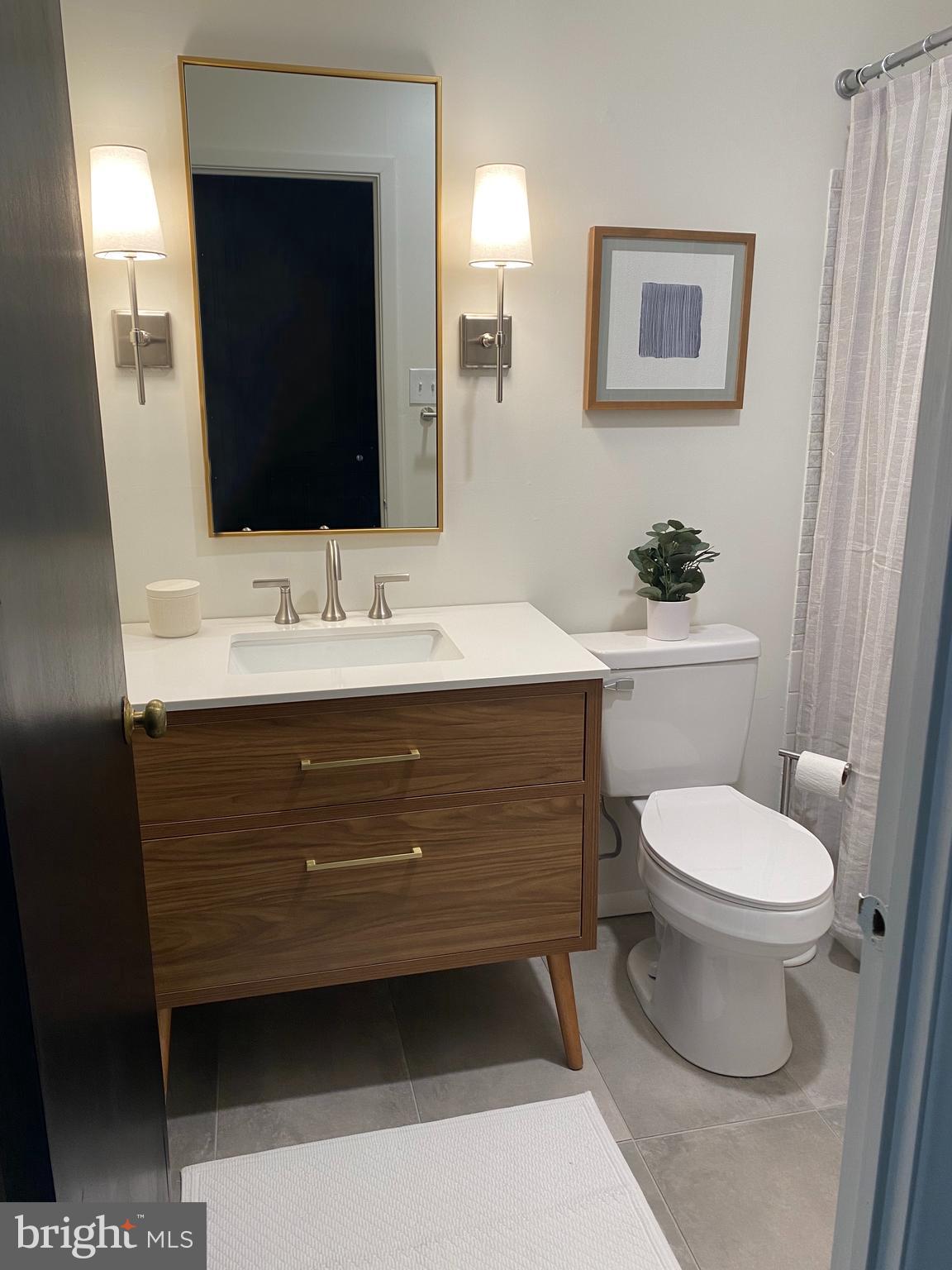 371 Old Forge Crossing, Unit 371 Devon, PA 19333 - Photo 2 of 10 a bathroom with a toilet sink and mirror