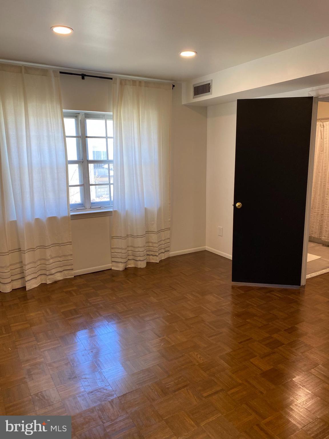 371 Old Forge Crossing, Unit 371 Devon, PA 19333 - Photo 4 of 10 a view of an empty room with wooden floor and a window