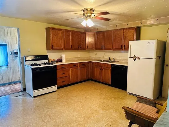 a kitchen with stainless steel appliances a stove a refrigerator and a sink