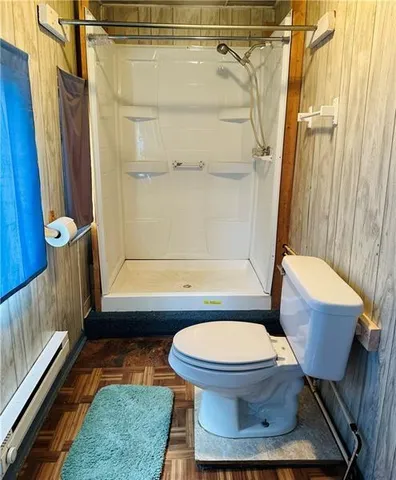 a bathroom with a toilet and a shower