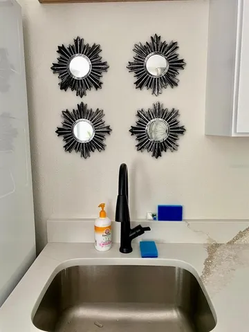 a bathroom sink with a potted plant