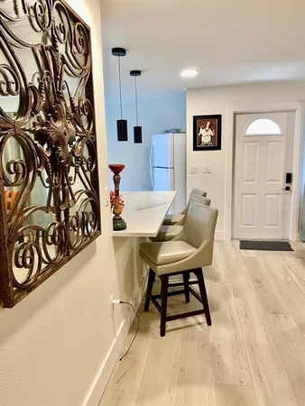 a view of a hallway with seating area