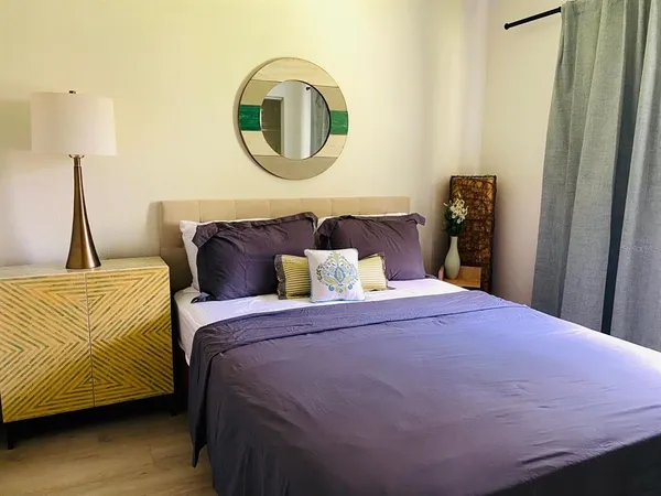 a bedroom with a bed and a mirror