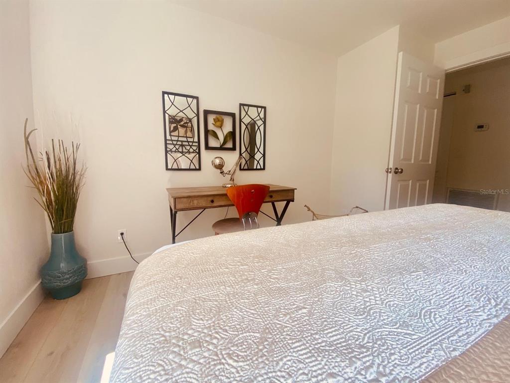 415 Mapleway, Unit A Safety Harbor, FL 34695 - Photo 22 of 50 a bedroom with a bed and chair